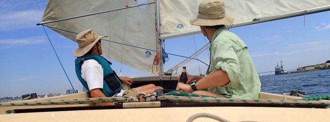 Two people drink on a boat